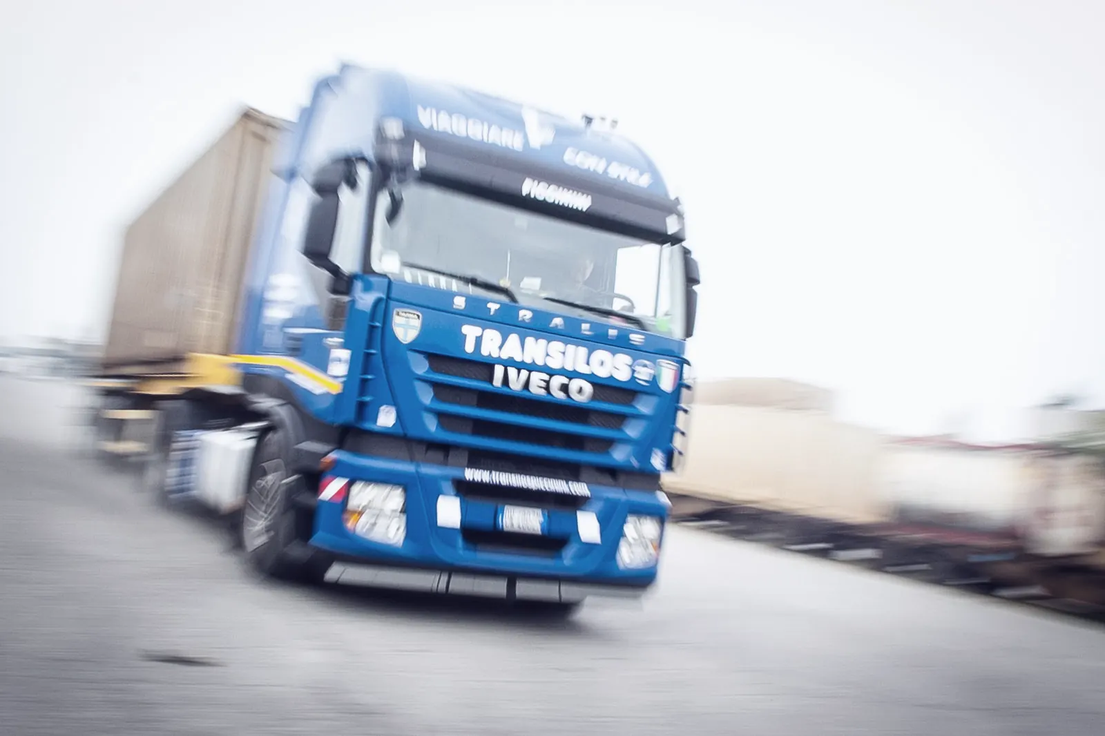 Transilos Piccinini Iveco tractor with container moving across the yard