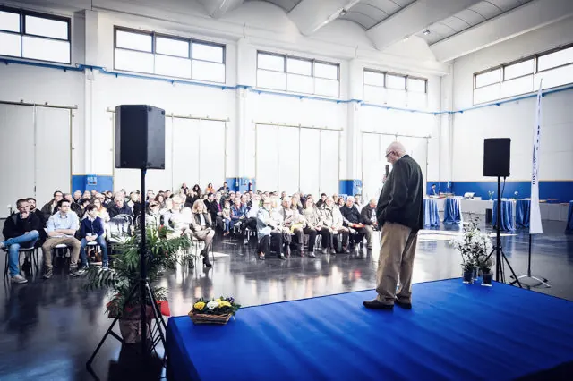 Audience seated in the shed during the opening speech for the new head office