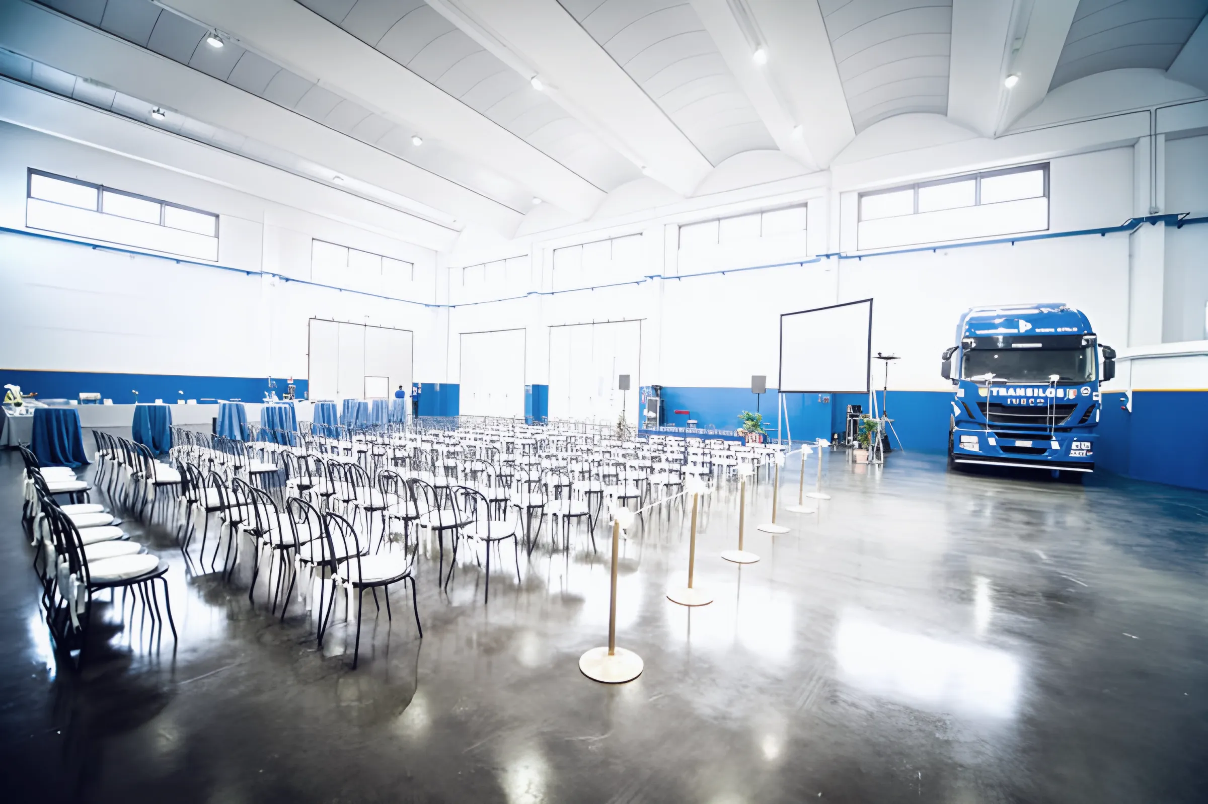 Shed set up with rows of chairs and a Transilos tractor for the opening