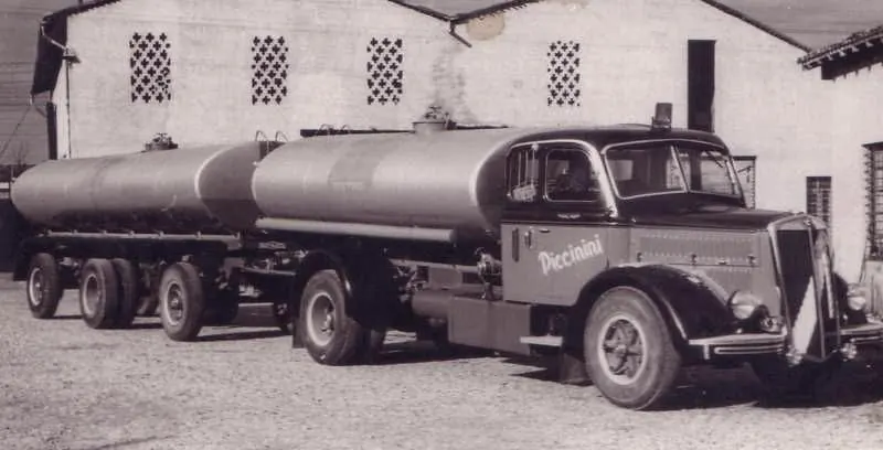 Vintage Piccinini tanker truck with tank trailer in front of a shed